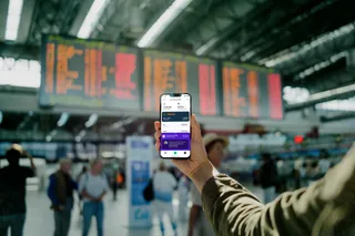 Sonya on a smartphone held in an airport